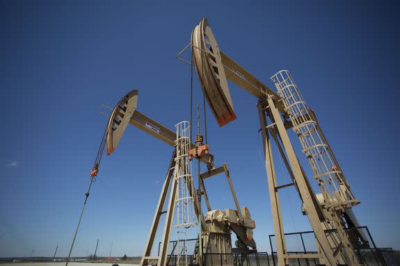 Injection wells pump waste water into the ground near Crescent, Oklahoma, March 31, 2016.