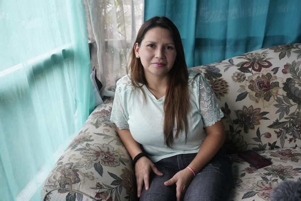 Deisy Mori sits at her home, Wednesday, Sept. 27, 2023, in Davie, Fla. Mori, her husband and daughter, originally from Venezuela, crossed six countries and entered the U.S., over a year ago. They were recently granted temporary protected status. (AP Photo/Marta Lavandier)