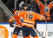 Edmonton Oilers' Darnell Nurse (25) and Zach Hyman (18) celebrate a goal against the Los Angeles Kings during the second period of an NHL hockey game in Edmonton, Alberta, Sunday, Dec. 5, 2021. (Jason Franson/The Canadian Press via AP)