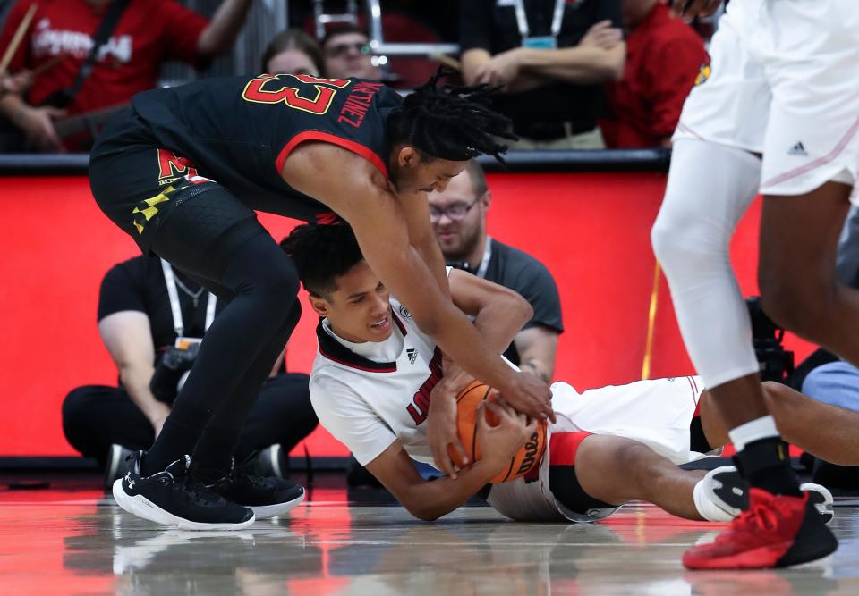 U of L's Fabio Basili (11) scrambles for a loose ball against a Maryland defender during their game at the Yum Center in Louisville, Ky. on Nov. 29, 2022.