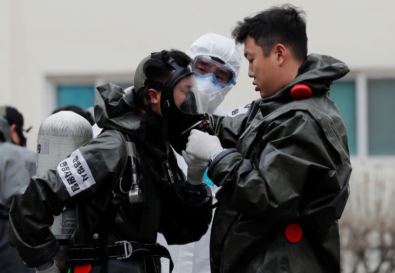 South Korean soldiers from a chemical corps prepare to carry out quarantine works at an apartment complex which is under cohort isolation after mass infection of coronavirus disease (COVID-19) reported in Daegu