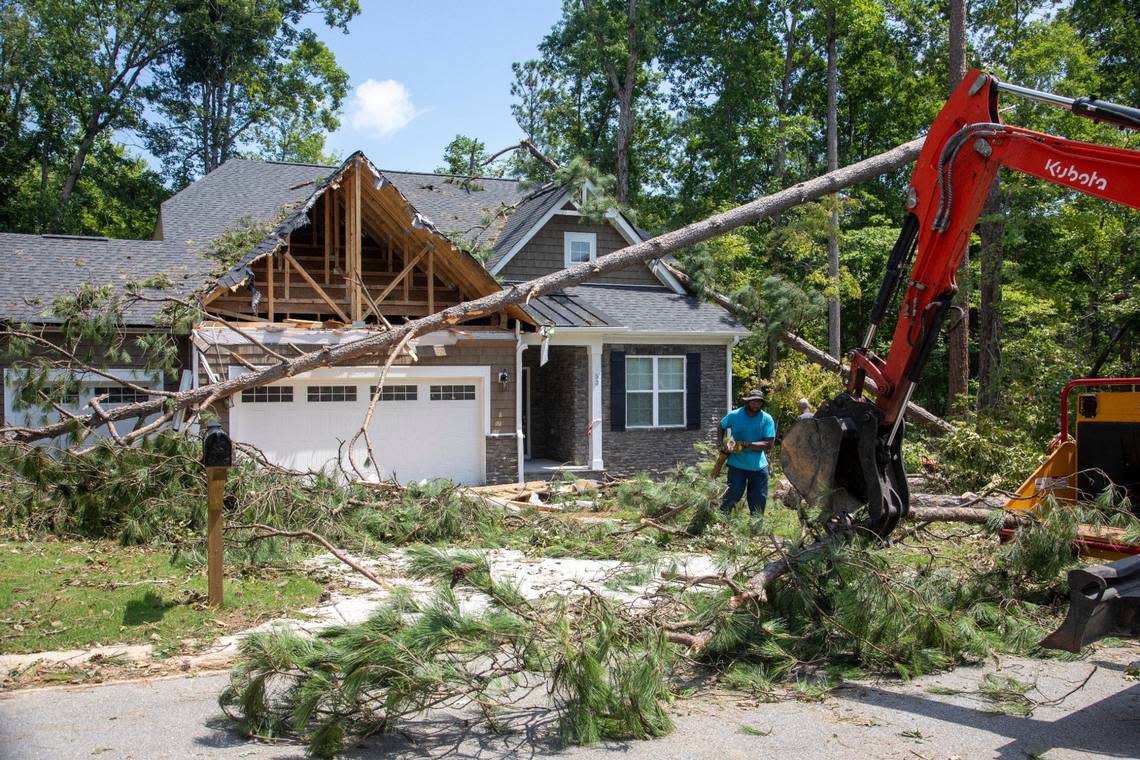 Workers clear debris from a tornado damaged home in the Belmont Lake Golf Club community in Rocky Mount Thursday, July 20, 2023. An EF3, tornado with wind speeds of 150 mph touched down in Nash County Wednesday around 12:30 p.m. Wednesday according to the Raleigh National Weather Service. Travis Long/tlong@newsobserver.com