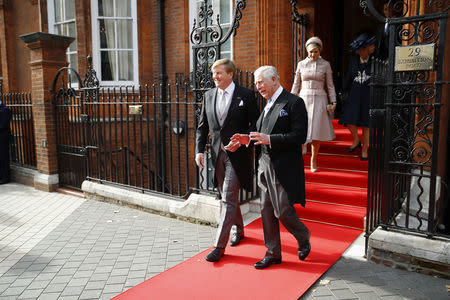 King Willem-Alexander of the Netherlands, leaves with Britain's Prince Charles, after an official welcome at the Dutch Ambassador's Residence at the start of a state visit by King Willem-Alexander and Queen Maxima of the Netherlands, in London, Britain October 23, 2018. Tolga Akmen/Pool via REUTERS