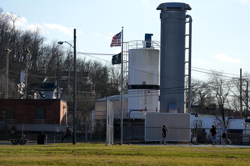 Three teens play ball against a backdrop of the Milford water tower near Victor Stier Drive and Race Street. Federal and state EPAs are planning to spend $3.3 million to clean up a contaminated aquifer in the city. For now, Milford is purifying its water at the tower.