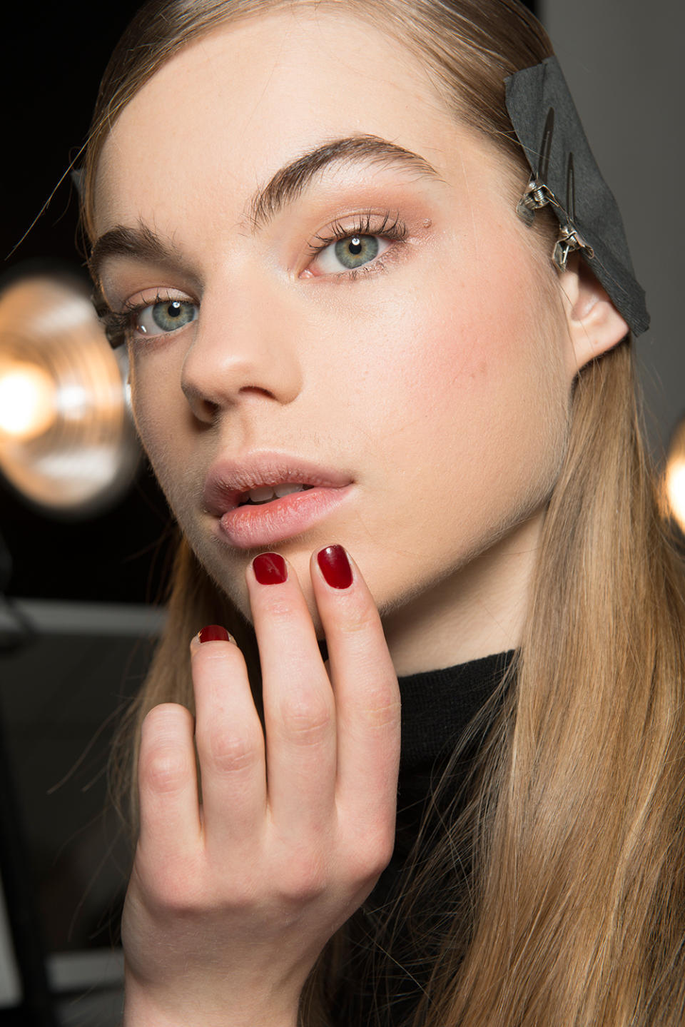 <p>According to nail tech Naomi Gonzalez for Zoya, the inspiration for the design was simple. Using a muted red to play off of the clean and uncomplicated lines of the designer creations, the choice of Zoya Courtney added a decidedly feminine power punch. (Photo: Imaxtree) </p>