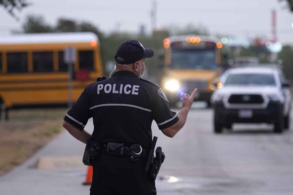 Southside Independent School District police officer Ruben Cardenas keeps watch as students arrive at Freedom Elementary School, Wednesday, Aug. 23, 2023, in San Antonio. Most Texas school districts say they are unable to comply with a new law requiring armed officers on every campus. The mandate was one of Republican lawmakers' biggest acts following the Uvalde school shooting in 2022 that killed 19 children and two teachers. (AP Photo/Eric Gay)