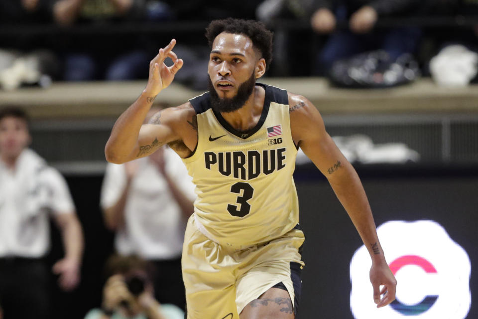 Purdue guard Jahaad Proctor (3) signals a 3-point basket against Virginia during the first half of an NCAA college basketball game in West Lafayette, Ind., Wednesday, Dec. 4, 2019. (AP Photo/Michael Conroy)