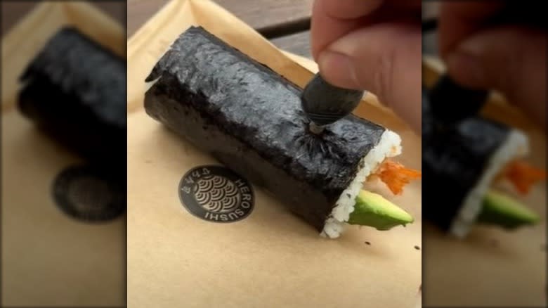 Sushi roll and soy-sauce fish packet