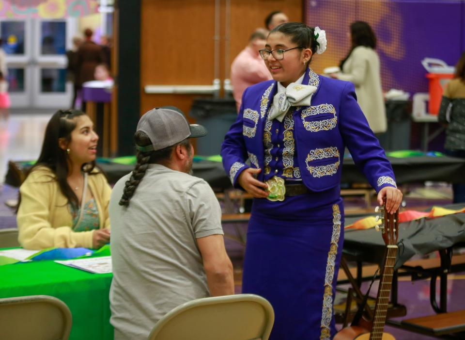 Denison High School junior Amy Estrada visits after performing with the Mariachi Reyes del Oeste.