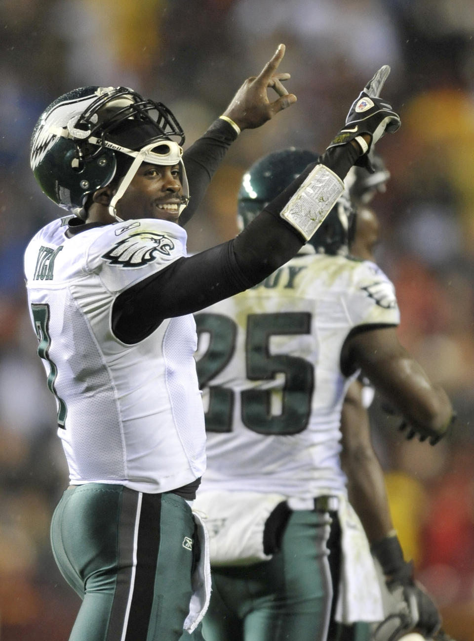 FILE - In a Nov. 15, 2010 file photo, Philadelphia Eagles quarterback Michael Vick celebrates after throwing a touchdown pass to wide receiver Jeremy Macli during the first half of an NFL football game against the Washington Redskins, in Landover, Md. The New York Jets signed quarterback Michael Vick and released Mark Sanchez on Friday, March 21, 2014. Vick was a free agent after spending the last five seasons with the Phialdelphia Eagles. (AP Photo/Gail Burton, File)