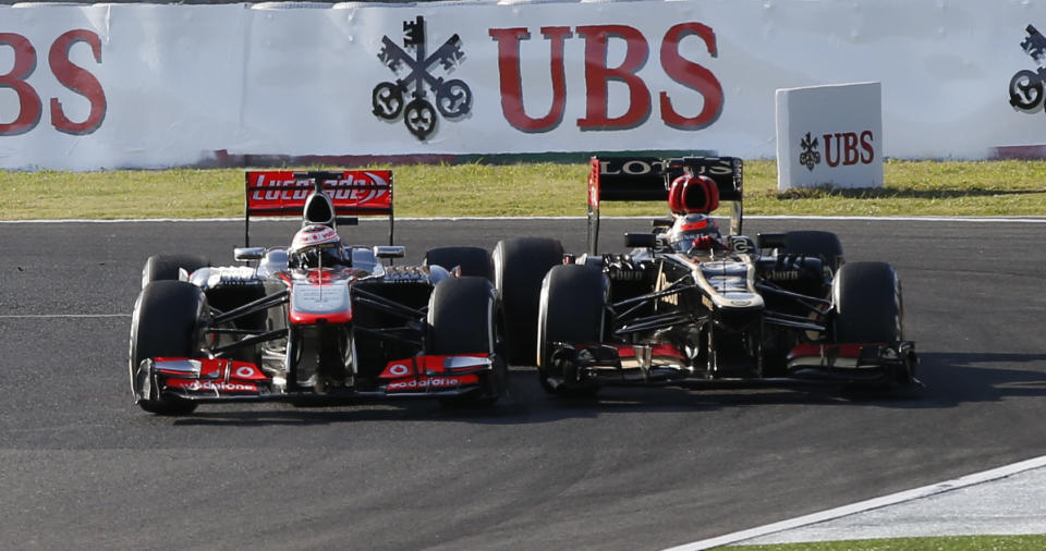 McLaren Formula One driver Jenson Button of Britain (L) and Lotus Formula One driver Kimi Raikkonen of Finland fight for a position during the Japanese F1 Grand Prix at the Suzuka circuit October 13, 2013. REUTERS/Toru Hanai (JAPAN - Tags: SPORT MOTORSPORT F1)
