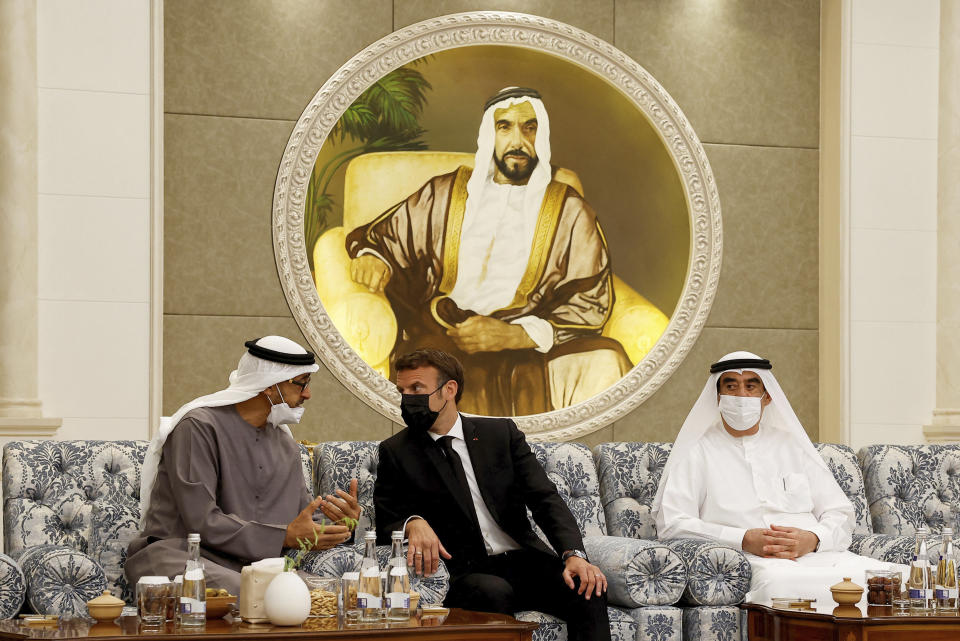 Newly-elected president of the United Arab Emirates Sheikh Mohammed bin Zayed Al Nahyan meets French President Emmanuel Macron, center, to mourn the death of Sheikh Khalifa Bin Zayed Al Nahyan at Al Mushrif Palace in Abu Dhabi, United Arab Emirates, Sunday, May 15, 2022. (Christian Hartmann, Pool via AP)