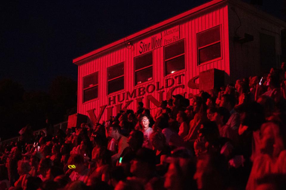 Attendees are bathed in light as the fireworks go off during opening day of the 2023 West Tennessee Strawberry Festival in Humboldt, Tenn. on Monday, May 8, 2023.