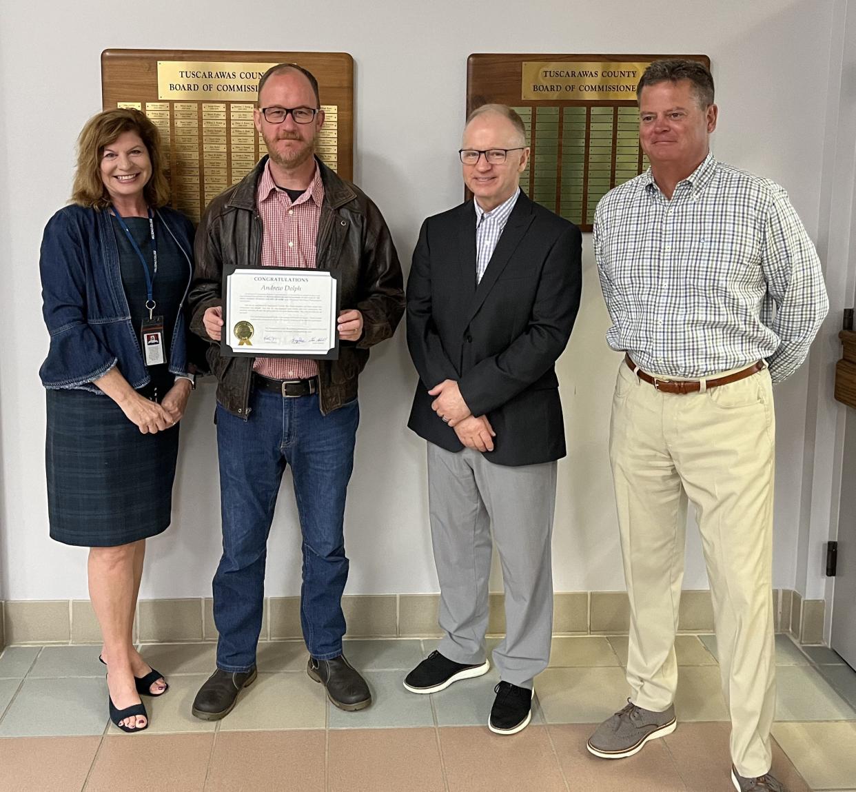 Times-Reporter photographer Andrew Dolph was honored Wednesday by Tuscarawas County commissioners for being named one of the Ohio News Photographers Association photographers of the year for 2023. Pictured with him are commissioners Kristin Zemis, Chris Abbuhl and Greg Ress.