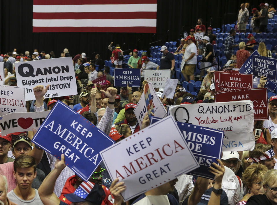 Trump supporters displaying QAnon posters appeared at a Trump rally Tuesday, July 31, 2018 at the Florida State Fair Grounds in Tampa Florida. (Photo: Thomas O'Neill/NurPhoto via Getty Images)