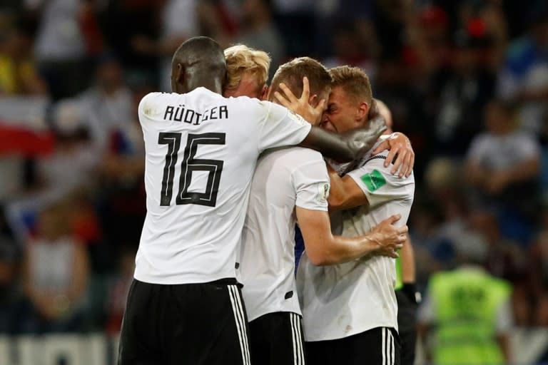 Relieved German players celebrate after Toni Kroos's winner against Sweden