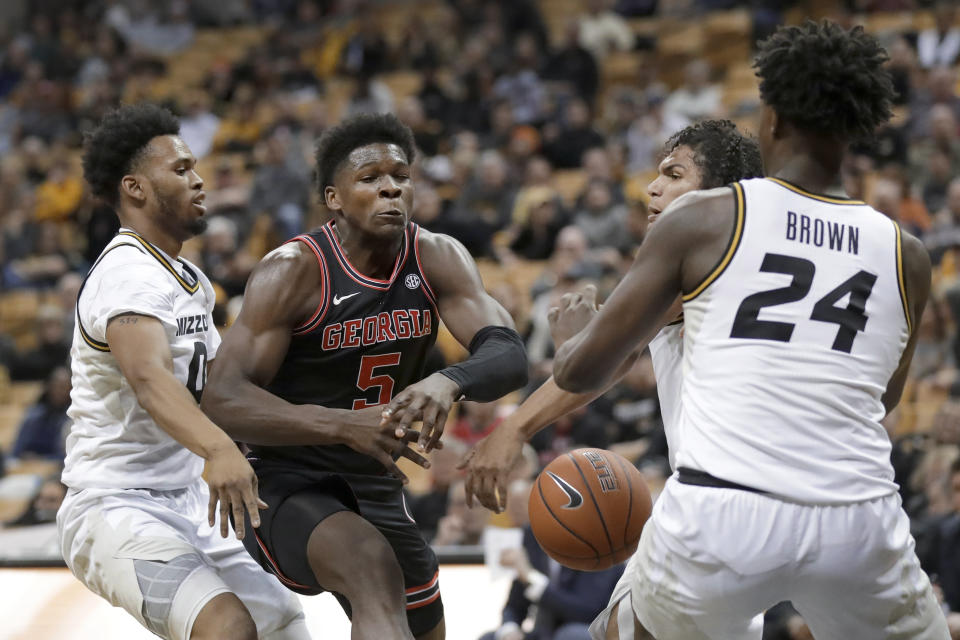Georgia's Anthony Edwards (5) loses control of the ball on his way to the basket as Missouri's Torrence Watson, left, and Kobe Brown (24) defend during the first half of an NCAA college basketball game Tuesday, Jan. 28, 2020, in Columbia, Mo. (AP Photo/Jeff Roberson)