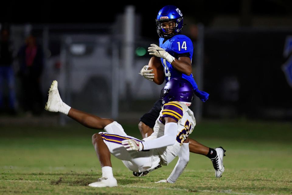 Trinity Christian Academy's London Smith (14) outmaneuvers Columbia's Jerome Carter (21) en route to a touchdown score during the first quarter of a regular season football game Friday, Sept. 23, 2022 at Trinity Christian Academy in Jacksonville.  