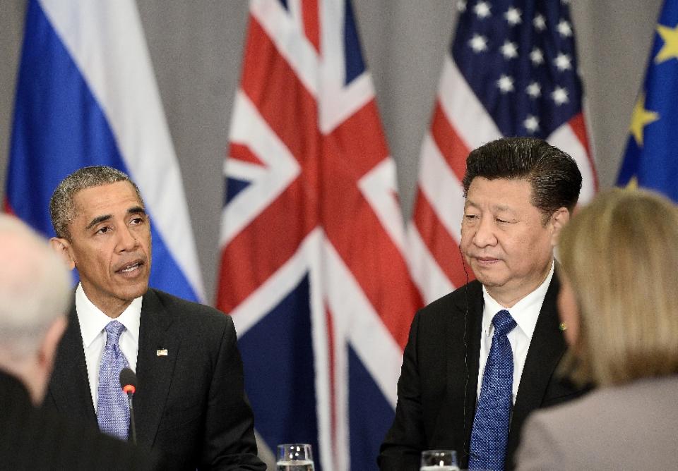 China's President Xi Jinping (R) listens to US President Barack Obama (L) in a P5+1 meeting during the Nuclear Security Summit at the Walter E. Washington Convention Center on April 1, 2016 (AFP Photo/Stephane De Sakutin)