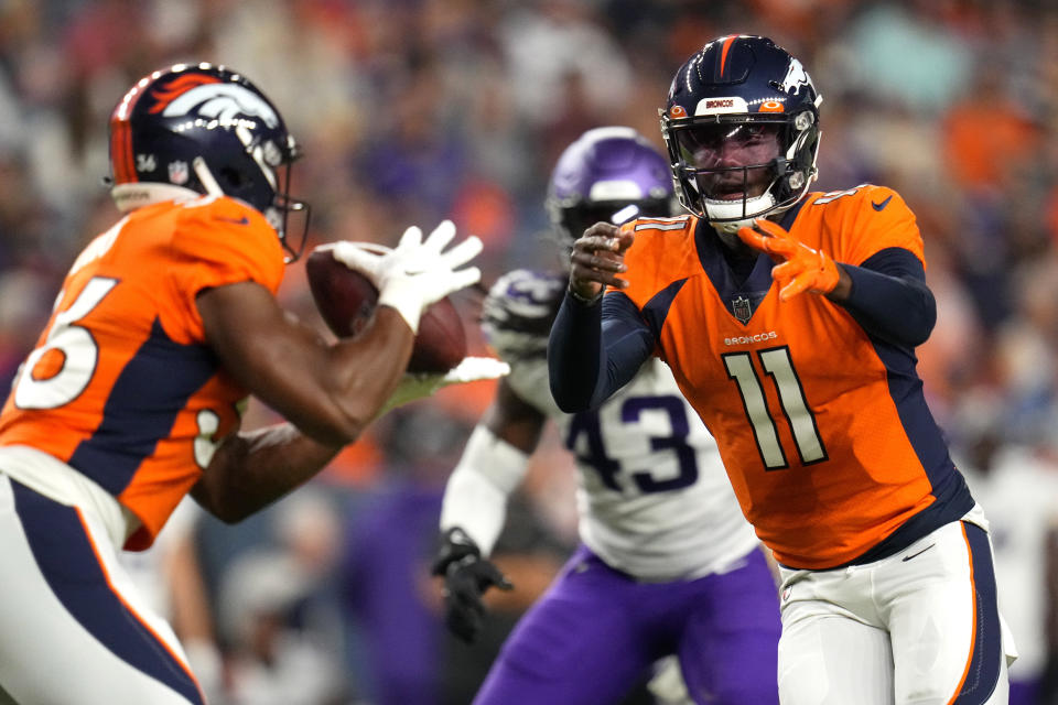 Denver Broncos quarterback Josh Johnson (11) hands off to running back Devine Ozigbo during the second half of an NFL preseason football game against the Minnesota Vikings, Saturday, Aug. 27, 2022, in Denver. (AP Photo/Jack Dempsey)