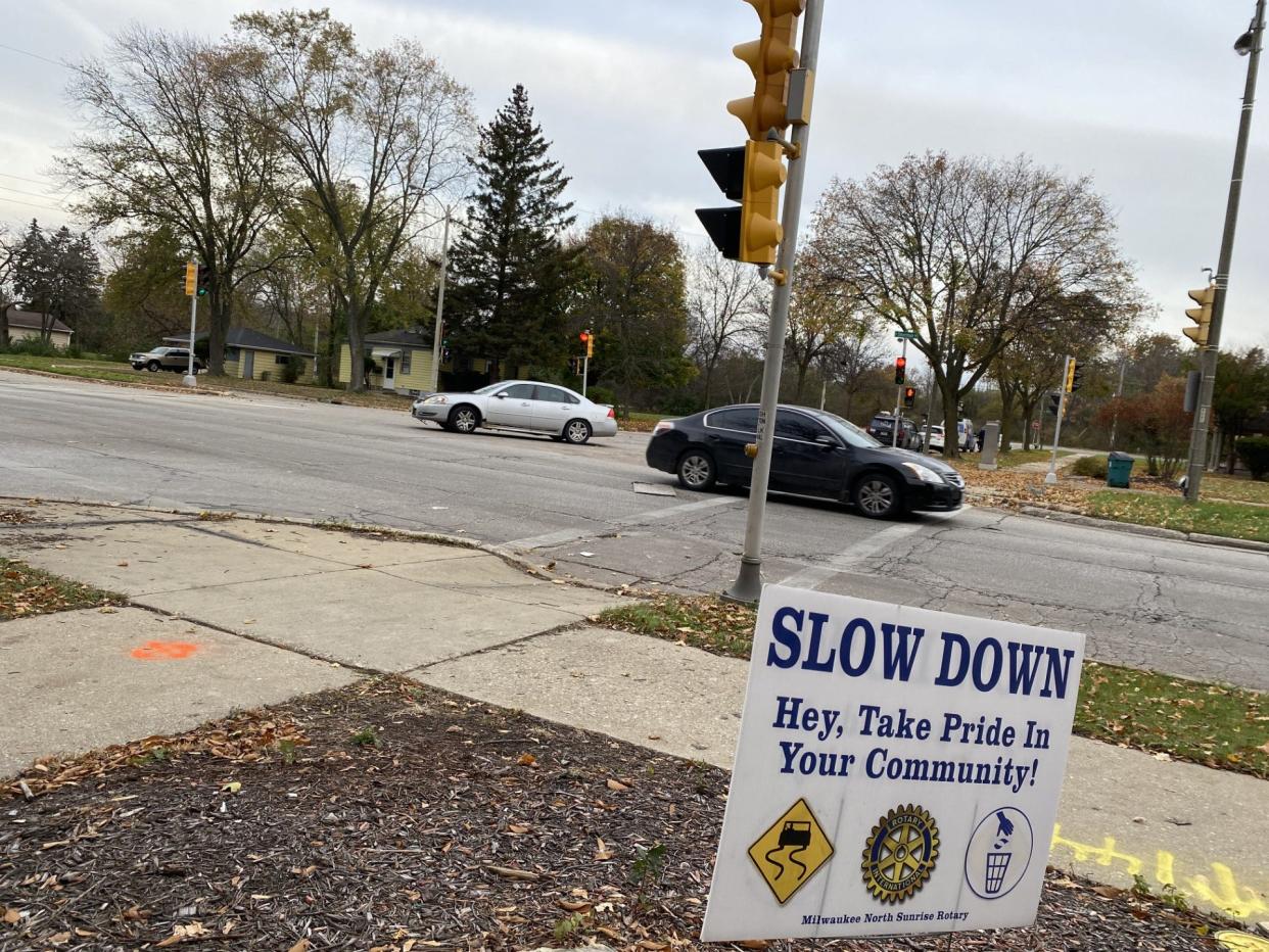 A lawn sign stationed at the intersection of North Sherman Boulevard and West Florist Avenue, where three people were killed in a crash Nov. 3, encouraged motorists to drive slowly.