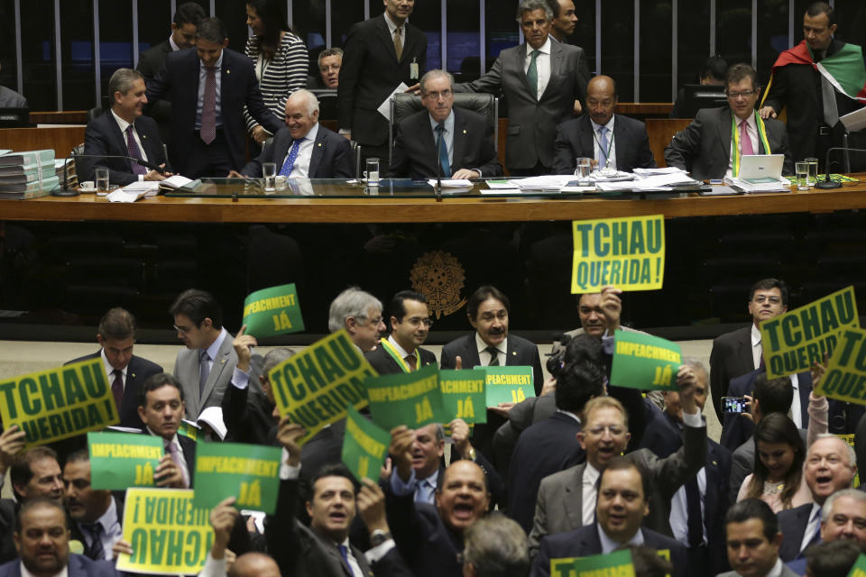 FILE - In this April 16, 2016, file photo, many lawmakers in favor of impeaching President Dilma Rousseff are seen holding signs saying "Tchau, Querida," or "Bye, Dear," during proceedings in the capital of Brasília on April 16, 2016. For many supporters of Rousseff, Brazil's first woman president, the use of the phrase "Bye, Dear" was emblematic of the sexism that the president faced during the process that ultimately led to her removal from office. (AP Photo/Eraldo Peres, File)