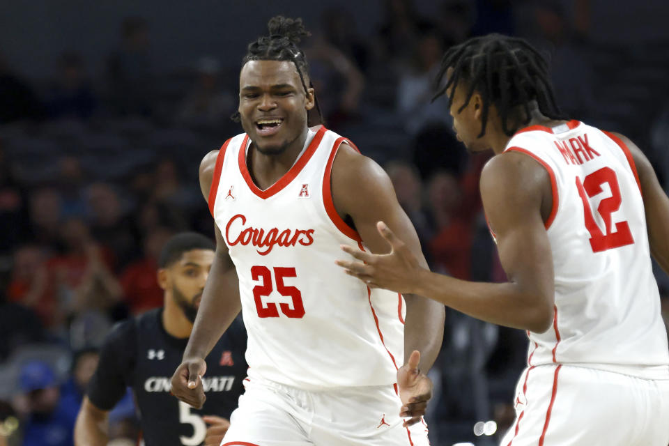 Houston forward Jarace Walker (25) celebrates with teammate and guard Tramon Mark (12) after a slam dunk against Cincinnati during the second half of an NCAA college basketball game in the semifinals of the American Athletic Conference Tournament, Saturday, March 11, 2023, in Fort Worth, Texas. (AP Photo/Ron Jenkins)