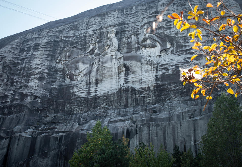 FILE - In this Oct. 5, 2020, a massive mountainside carving depicting Confederate leaders Jefferson Davis, Robert E. Lee and Stonewall Jackson is shown, in Stone Mountain, Ga. In the shadow of the world’s largest memorial to the Confederacy, the City of Stone Mountain will host its first-ever Juneteenth celebration this summer. (AP Photo/Ron Harris, File)