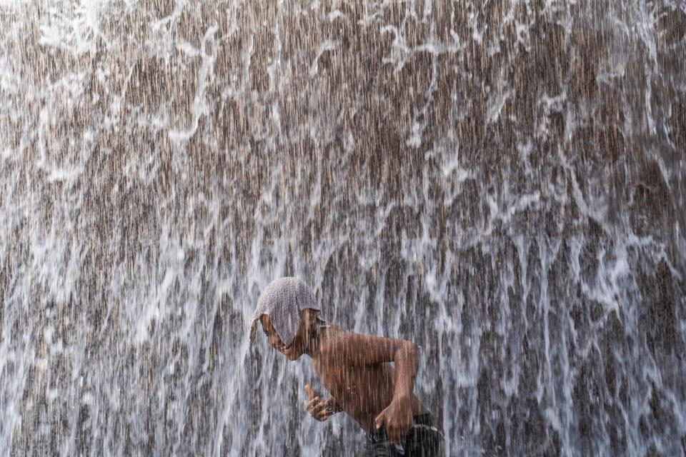 Royce Mauldin, of Detroit, makes an attempt to end up at the center of Dodge Fountain in Hart Plaza after several attempts while finding relief from the heat in downtown Detroit on Monday, June 17, 2024.