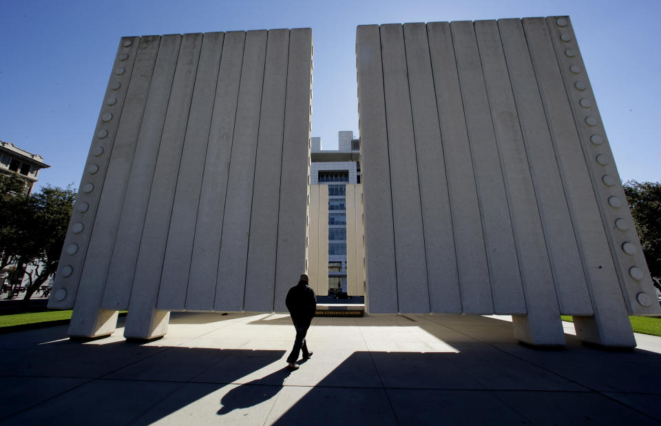 In this Tuesday, Nov. 12, 2013 file photo, Chris Carson of Ashville, N.C. visits the John Fitzgerald Kennedy Memorial in downtown Dallas. Dallas is a city that likes to do things big, but that doesn’t mean you’ll have to sell the ranch to have a good time here. (AP Photo/LM Otero)