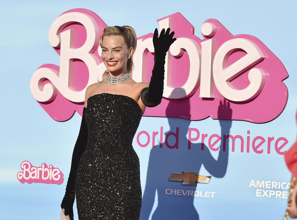 Margot Robbie in a black sheath and long black gloves at a Barbie premiere