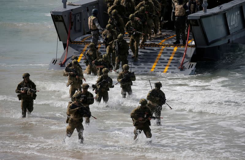 FILE PHOTO: Soldiers from the Australian Army's 3rd Brigade step onto Langham Beach after an amphibious assault landing during the Talisman Saber joint military exercises