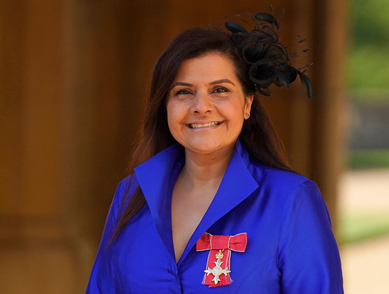 Nina Wadia poses with her medal after being appointed an Officer of the Order of the British Empire (OBE) during an investiture ceremony at Windsor Castle, in Windsor, on February 9, 2022. (Photo by Steve Parsons / POOL / AFP) (Photo by STEVE PARSONS/POOL/AFP via Getty Images)