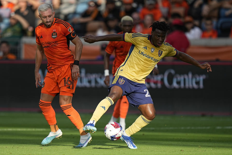 Real Salt Lake midfielder Emeka Eneli, right, takes the ball away from Houston Dynamo midfielder Héctor Herrera (16) during the first half of an MLS playoff soccer match, Sunday, Oct. 29, 2023, in Houston. (AP Photo/Kevin M. Cox)