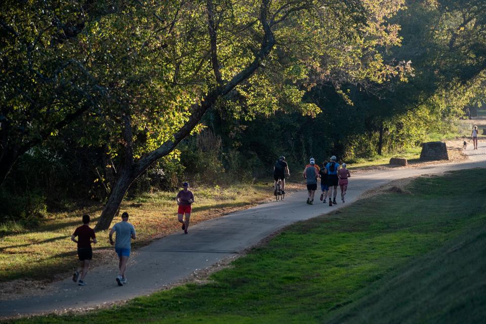 People run on the French Broad River Greenway, October 3, 2023. The greenway will see a connecting unpaved trail through the city supported program titled AVL Unpaved.