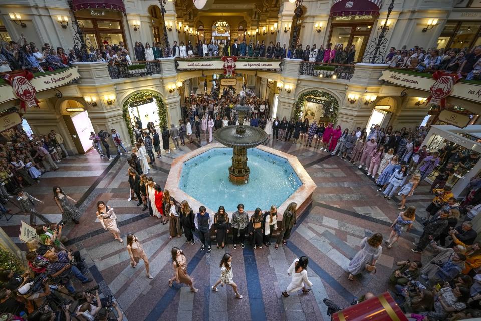 Models display the collection by a group of Russian designers inside the GUM department store with lots of boutiques closed due to sanctions during the opening of the Fashion Week in Moscow, Russia, Monday, June 20, 2022. Chic and adventurous models and couturiers have been spread all over the Russian capital for Moscow Fashion Week, flaunting their designs in venues ranging from a sprawling Stalin-era propaganda exposition to a large park near the Kremlin admired for its innovative features. (AP Photo/Alexander Zemlianichenko)