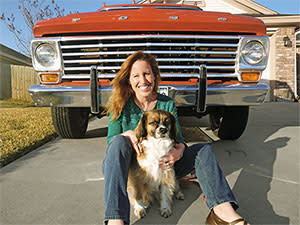 woman with dog by car