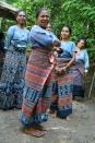 Proud weavers: Members of the Threads of Life weaving group from Bliran Sina in Maumere, Flores show off their work. (