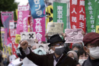 People chant slogans against government's decision to start releasing massive amounts of treated radioactive water from the wrecked Fukushima nuclear plant into the sea, during a rally outside the prime minister's office in Tokyo Tuesday, April 13, 2021. The decision, long speculated but delayed for years due to safety concerns and protests, came at a meeting of Cabinet ministers who endorsed the ocean release as the best option. (AP Photo/Eugene Hoshiko)