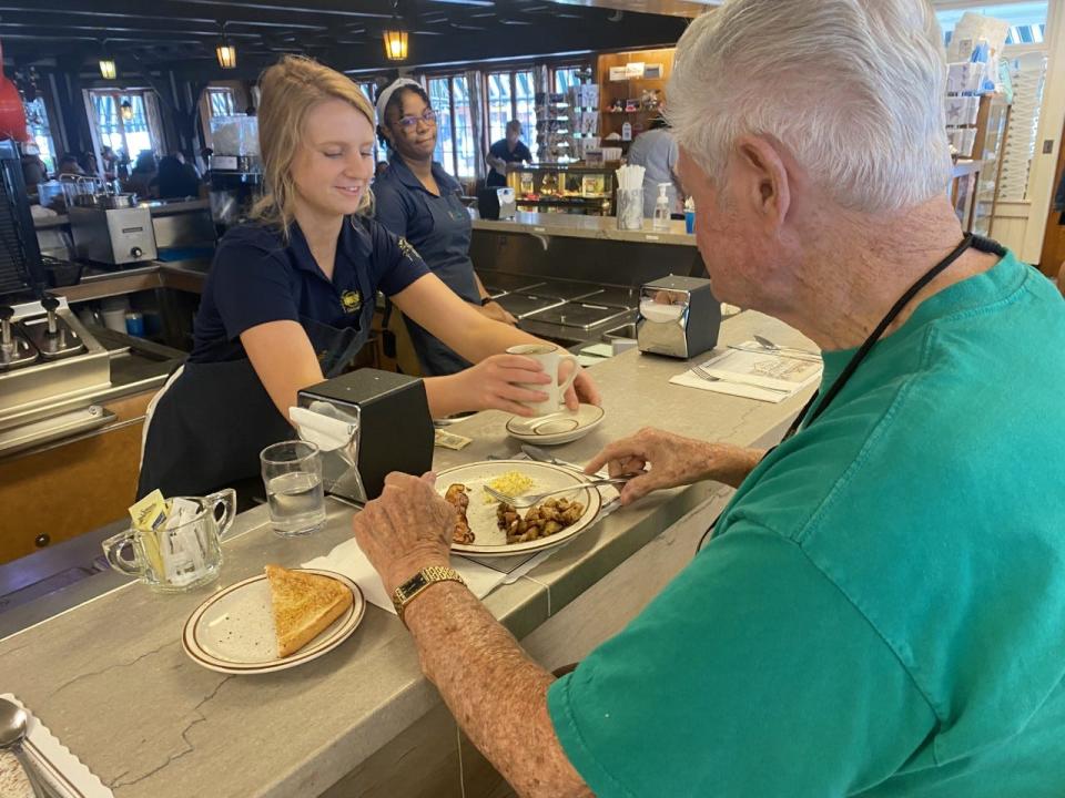 Elise Gillis serves Philip Forde his coffee at the Goldenrod at York Beach, where staff look forward to a busy 2022 season.