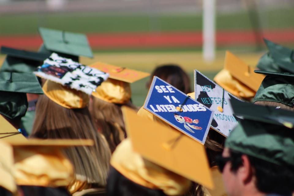 A student's cap that says "See ya later dudes," at the Pueblo County High School commencement ceremony at Hornet Stadium on Saturday.