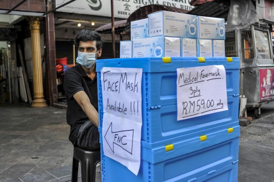 A vendor sells face masks in Kuala Lumpur April 14, 2020. — Picture by Shafwan Zaidon