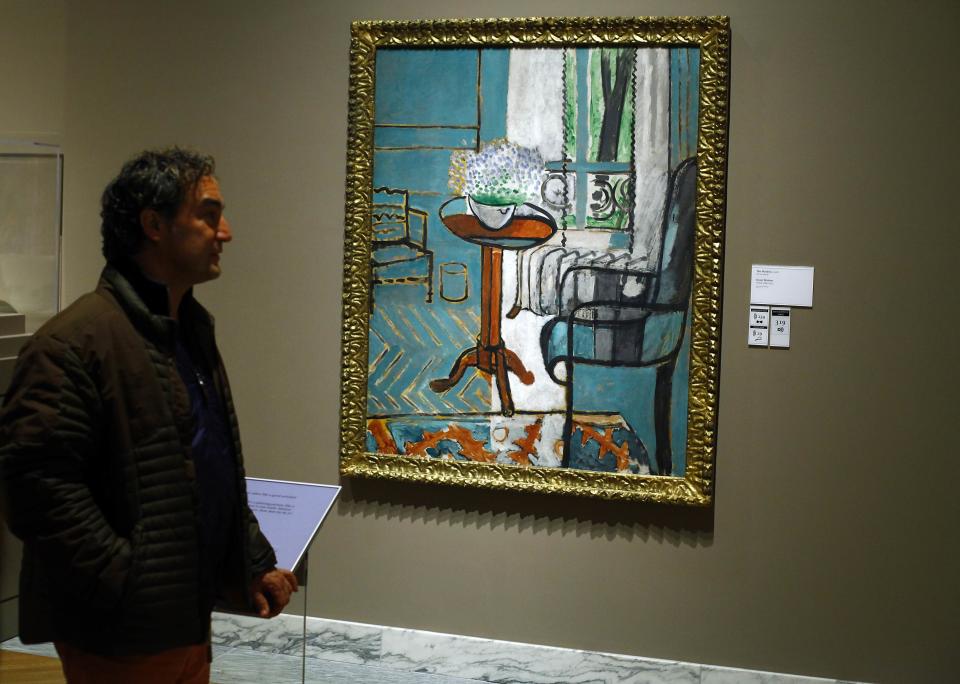 A man looks at a painting titled "The Window" by artist Henri Matisse displayed at the Art Institute of Detroit in Detroit
