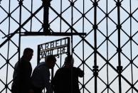 Workers fix the new entrance gate with the inscription 'Work sets you free' (Arbeit macht frei) in the former concentration camp in Dachau, southern Germany, on April 29, 2015