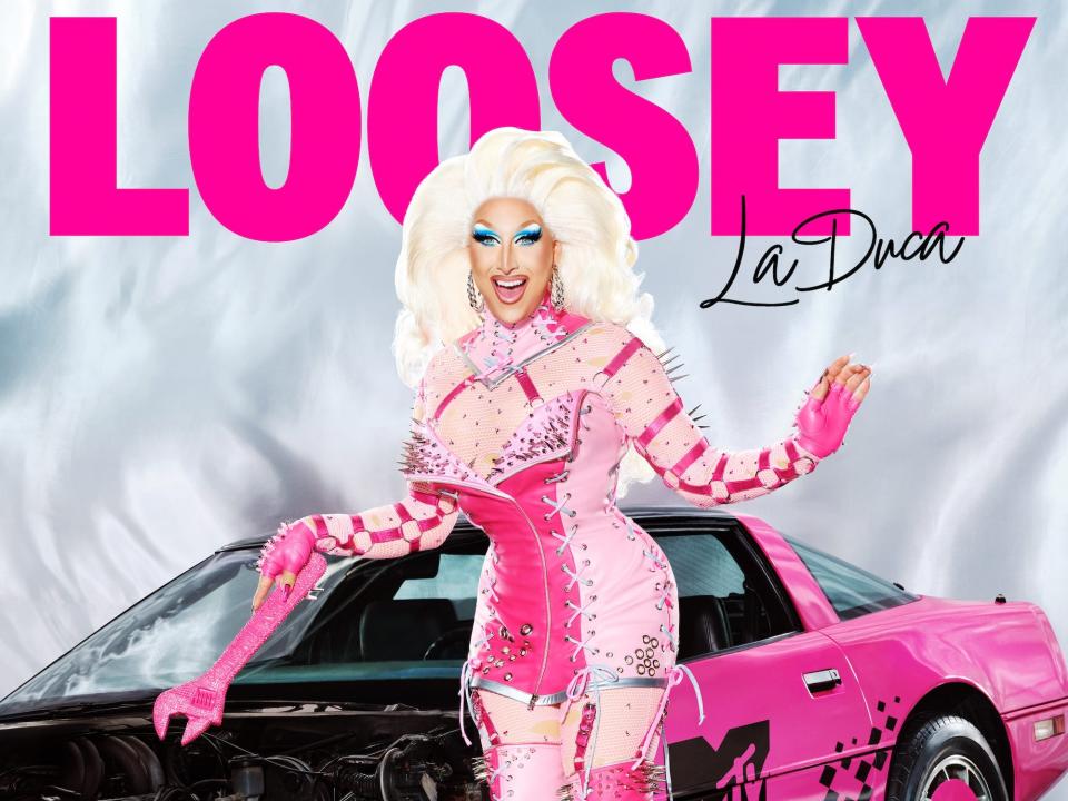 Loosey LaDuca poses for her "RuPaul's Drag Race" season 15 headshot in a pink corset gown with matching legwarmers and heels.
