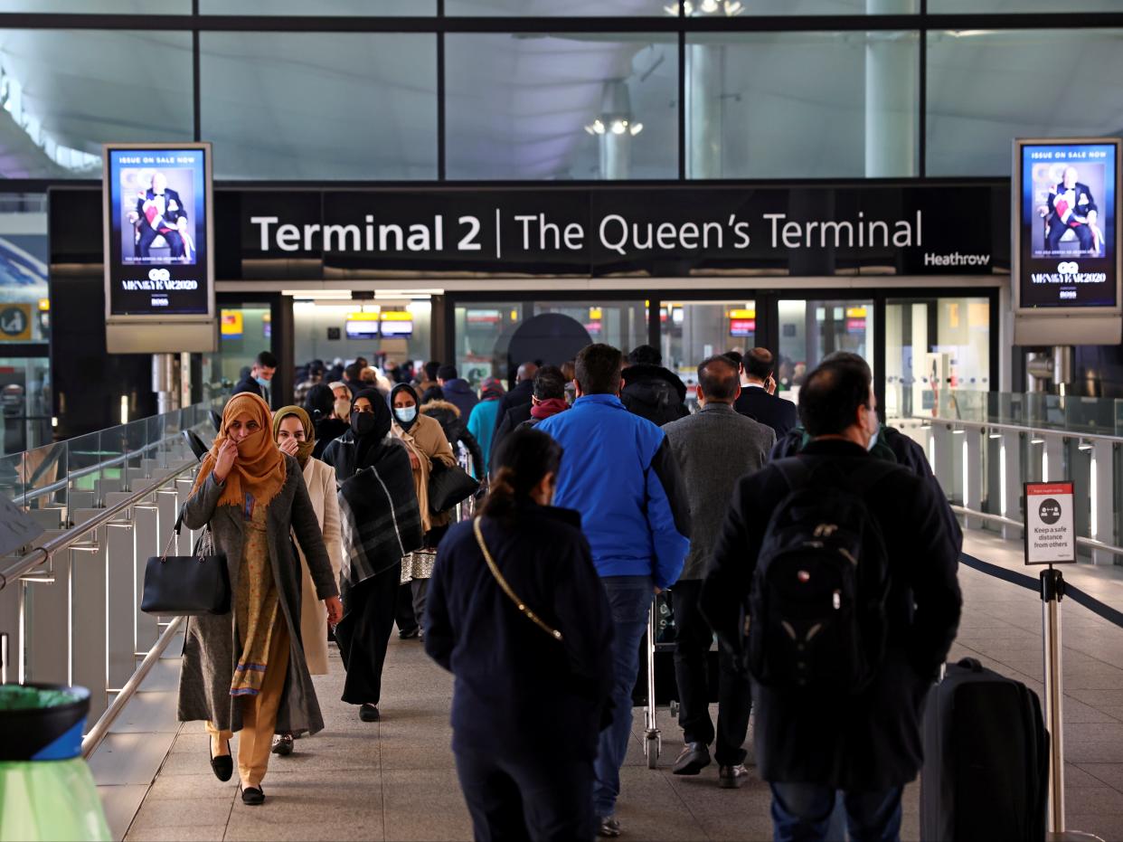 <p>People queue to enter terminal 2, as tighter rules for international travellers start, at Heathrow Airport</p> (Reuters)