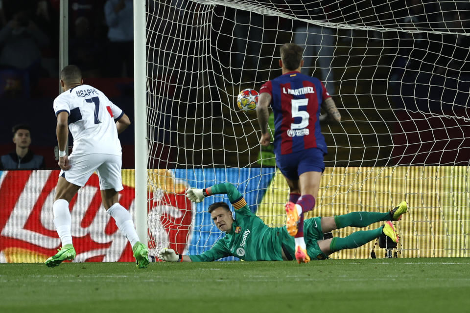 PSG's Kylian Mbappe scores his side's 3rd goal on a penalty kick during the Champions League quarterfinal second leg soccer match between Barcelona and Paris Saint-Germain at the Olimpic Lluis Companys stadium in Barcelona, Spain, Tuesday, April 16, 2024. (AP Photo/Joan Monfort)