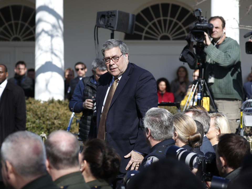 Attorney General William Barr stands at the direction of President Donald Trump during an event in the Rose Garden at the White House to declare a national emergency in order to build a wall along the southern border, Friday, Feb. 15, 2019 in Washington. (AP Photo/Pablo Martinez Monsivais)