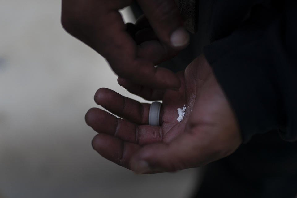 A homeless addict holds pieces of fentanyl in Los Angeles, Thursday, Aug. 18, 2022. Use of the powerful synthetic opioid that is cheap to produce and is often sold as is or laced in other drugs, has exploded. Because it's 50 times more potent than heroin, even a small dose can be fatal. It has quickly become the deadliest drug in the nation, according to the Drug Enforcement Administration. (AP Photo/Jae C. Hong)