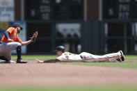 Houston Astros' Jose Altuve, left, tags out San Francisco Giants' Mike Yastrzemski on a runner's fielder's choice during the third inning of a baseball game in San Francisco, Saturday, July 31, 2021. (AP Photo/Jed Jacobsohn)